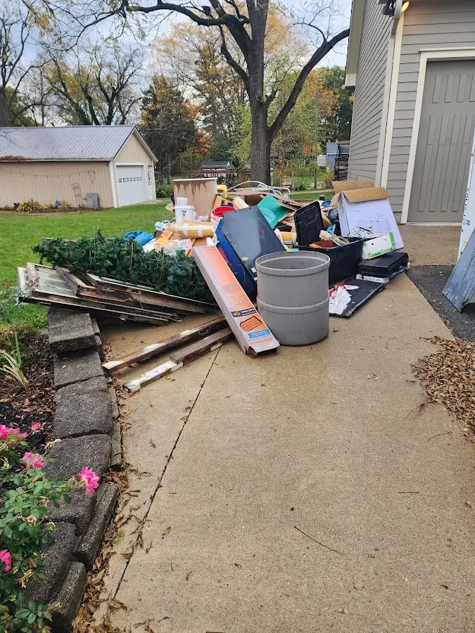 Dumpster being loaded with debris for Estate Cleanout Dumpster Rental in Ottumwa